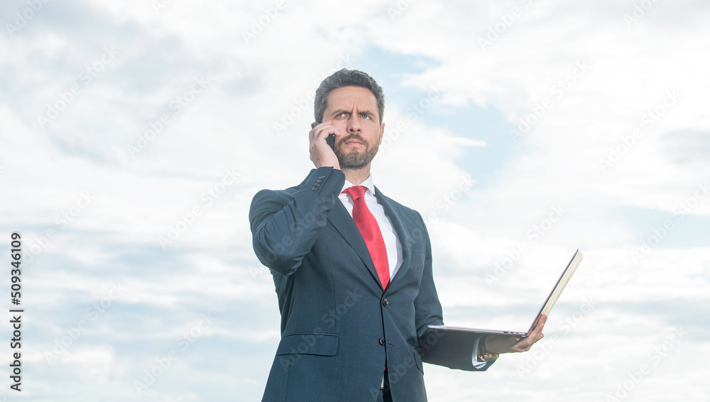 businessman in suit talk on phone and hold laptop businessman in suit talk on phone and hold laptop