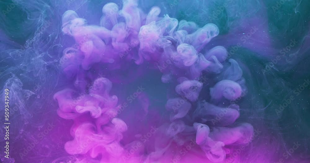 Paint water blend. Magic spell. Chemical reaction. Neon pink blue purple color ink drop motion on vapor texture abstract background shot on Red Cinema camera 6k.