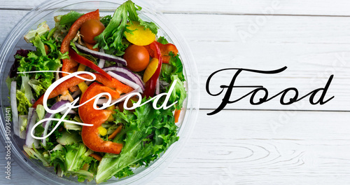 Image of good food text in black and white, over bowl of fresh salad on white wooden boards