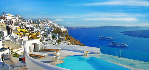 luxury summer destinations . Greece, Santorini - most beautiful romantic island. View of Oia village and caldera with cruise ships