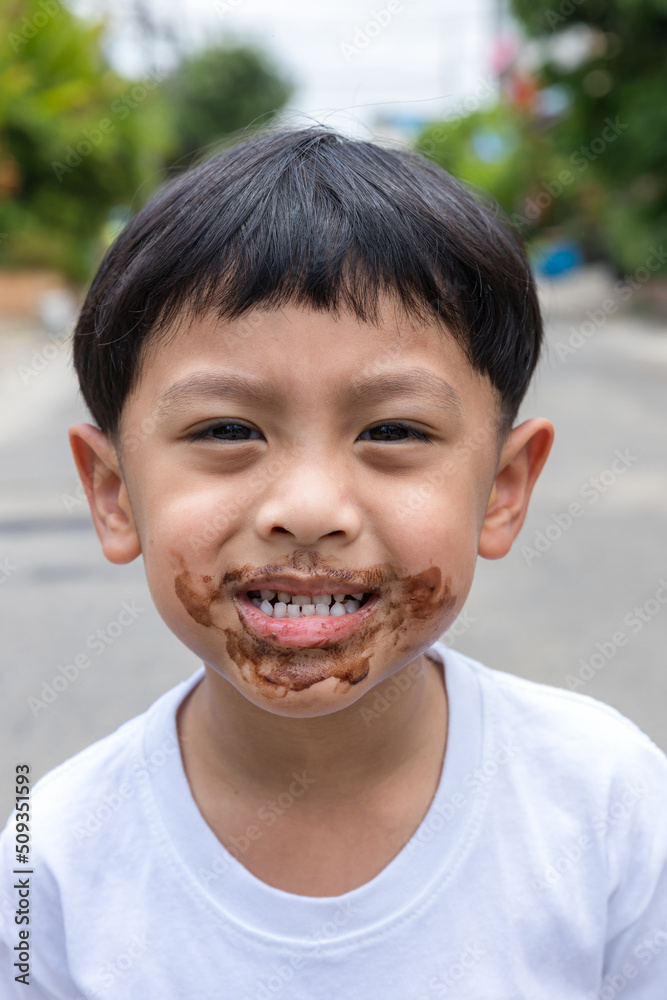 Child face messy and dirty by chocolate ice cream. Child with face covered in chocolate. Child face messy and dirty by chocolate ice cream. Child with face covered in chocolate.