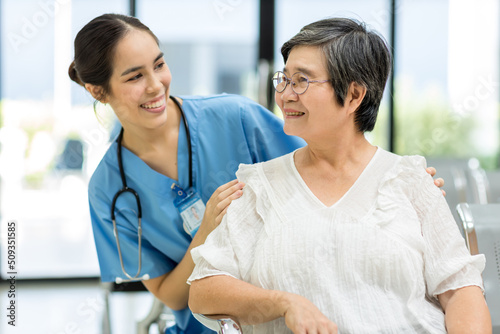 Nurse take care Elderly patient in hospital ward. Elderly woman sit down at hospital. Senior woman at hospital for a check-up