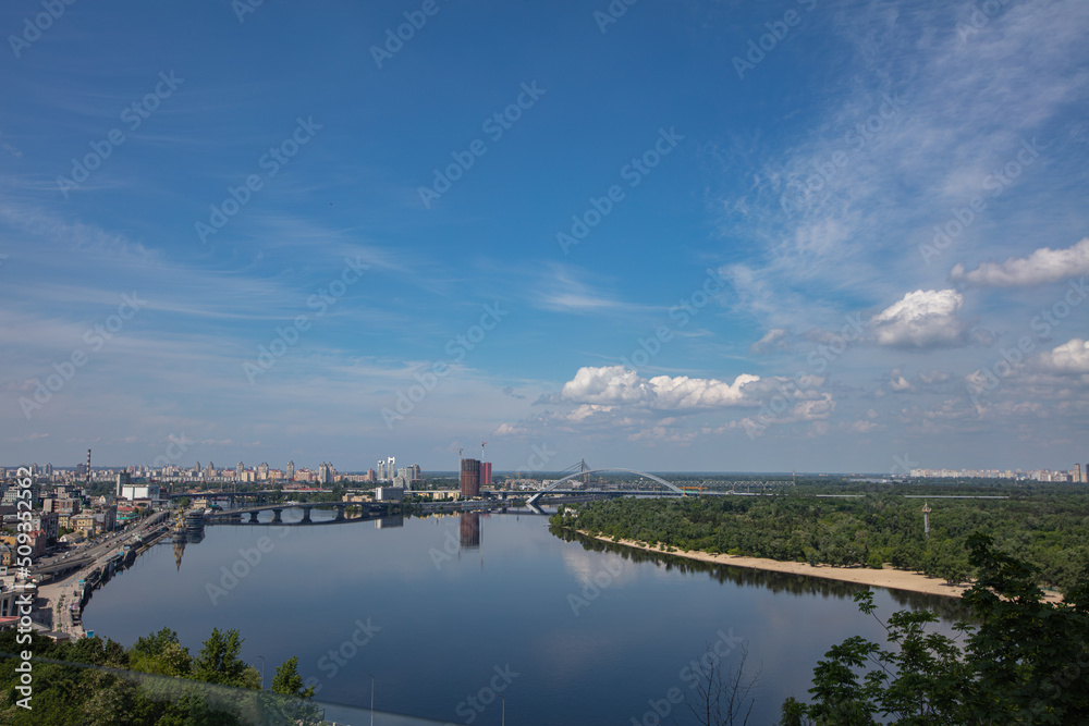 View on Dnipro river from pedestrian and bicycle bridge across Saint Volodymyr descent  in Kyiv, Ukraine