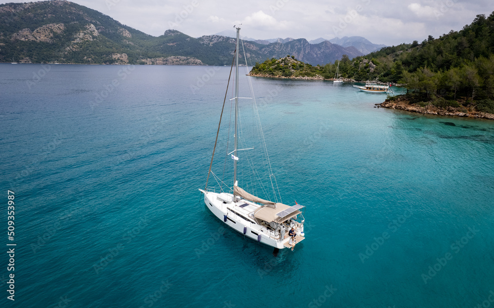 Sailing boat at blue sea from above (aerial drone photo)
