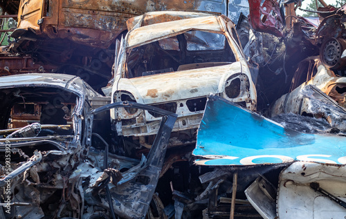 A lot of rusty burnt cars in Irpen  after being shot by the Russian military. Russia s war against Ukraine. Cemetery of destroyed cars of civilians who tried to evacuate from the war zone.