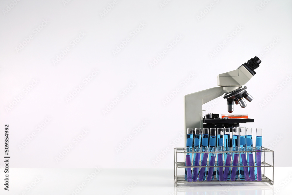 Concept of research and development of science laboratories microscope with test tube on the table and white background