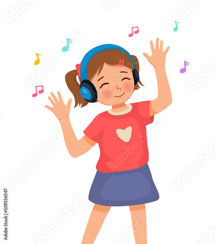 Happy cute little girl dancing while listening to music with headphone 