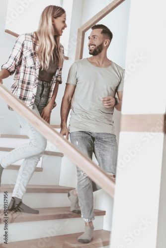 happy couple on the stairs in their new apartment.