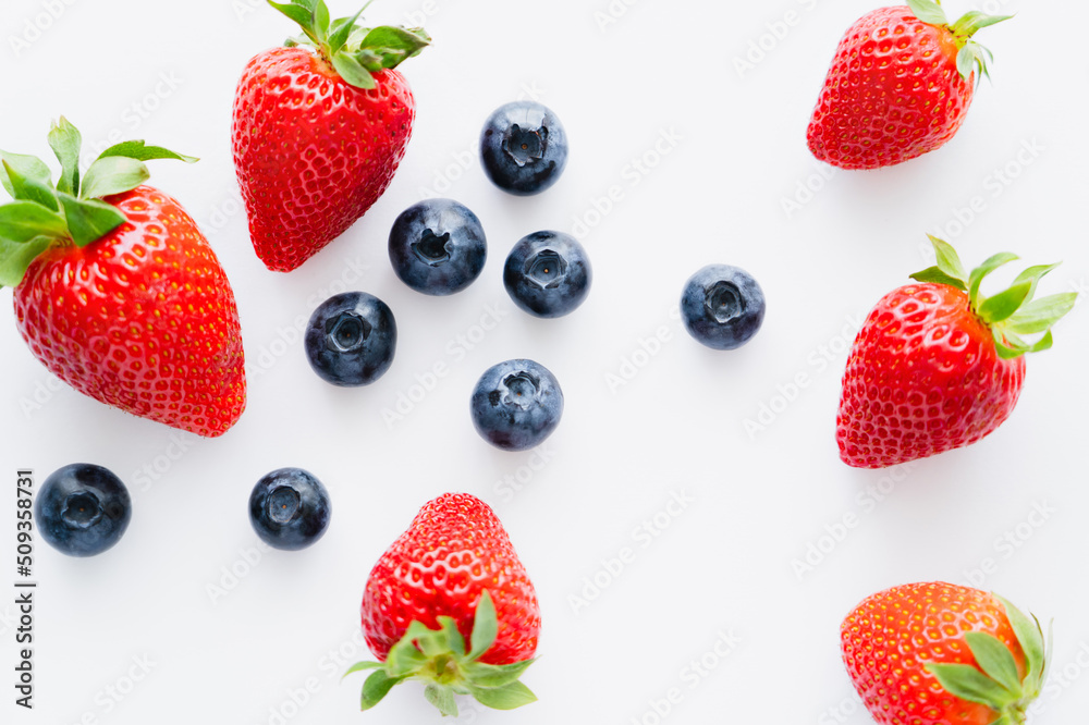 Top view of fresh berries on white background.