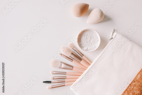 Makeup accessories, brushes and sponges,pink pastel background,flat layot