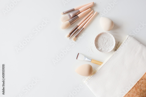 Makeup accessories  brushes and sponges pink pastel background flat layot