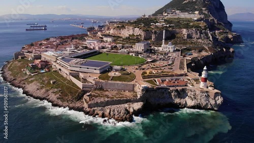 Aerial View Of Europa Point In Gibraltar With Waves Crashing Onto Rocks. Pedestal Down