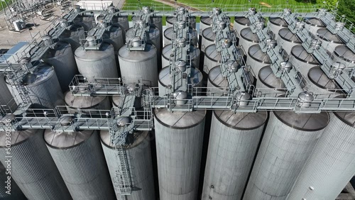 Silos and stainless steel tanks for beer fermentation. Industrial factory manufacturing in America theme. USA brewery. photo