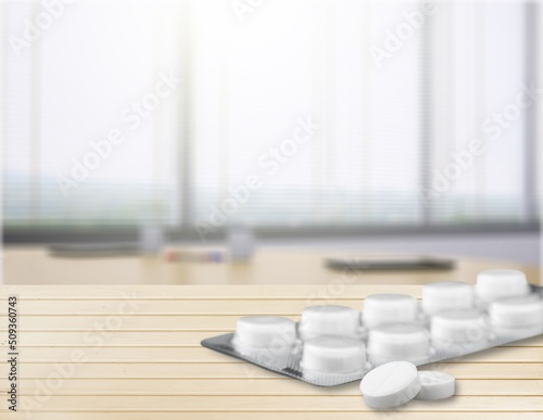White blister tablets on pastel background