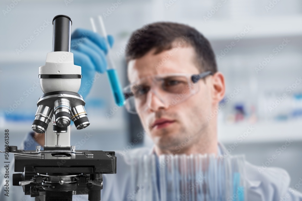 Woman chemist holds flask with liquid in hands in the chemical laboratory. Quality control of petrochemical products concept. Woman chemist holds flask with liquid in hands in the chemical laboratory. Quality control of petrochemical products concept.