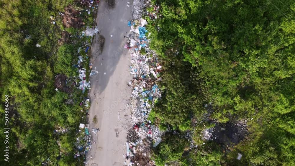 Aerial fly over rural path with illegal rubbish dump Aerial fly over rural path with illegal rubbish dump