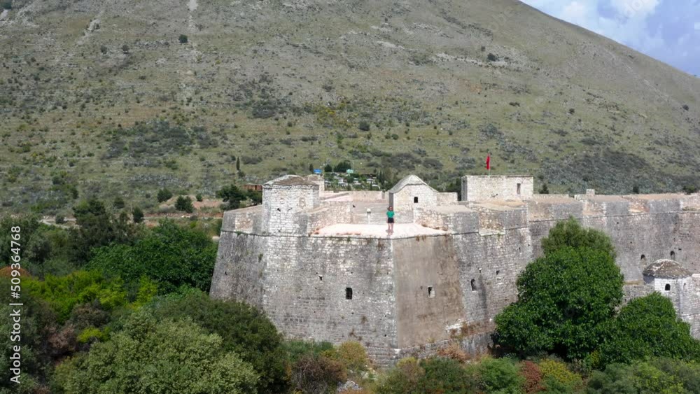 Aerial view of a person standing on top of Ali Pasha Castle in Porto Palermo bay, Albania. Aerial view of a person standing on top of Ali Pasha Castle in Porto Palermo bay, Albania.