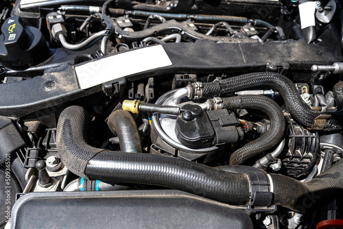 New fuel filter installed on a modern diesel car in the engine compartment.