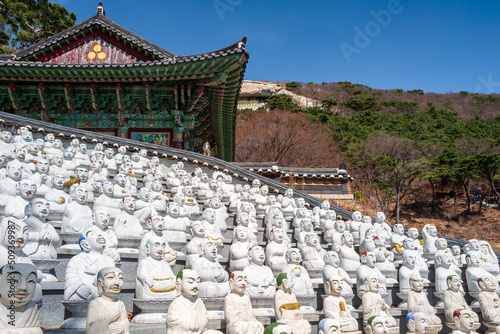 Many of the 500 Buddha’s Disciples statues by a temple hall in Bomunsa Temple on the island of Seongmodo, Ganghwa, Incheon, South Korea.