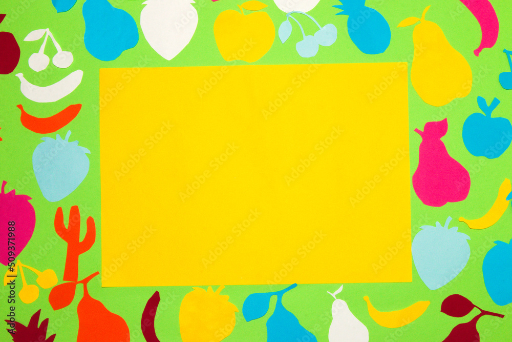 green background with colorful paper fruits in the middle yellow paper as copy space, creative art summer design, time for vitamins