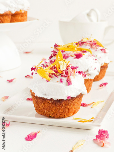 Cake with edible flowers and whipped cream. Shallow dof .