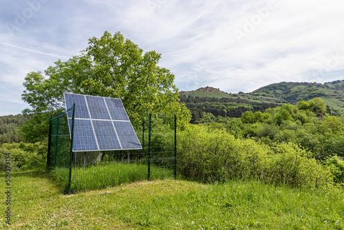 Large solar panel installed in a park area among the forest