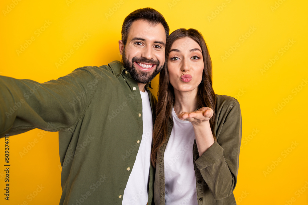 Photo of cute couple spend vacation together make video vlog take selfie isolated on yellow color background Photo of cute couple spend vacation together make video vlog take selfie isolated on yellow color background