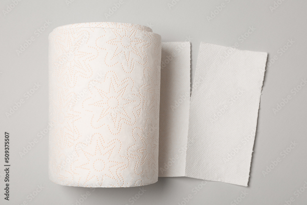 Roll of white paper towels on grey background, top view Roll of white paper towels on grey background, top view