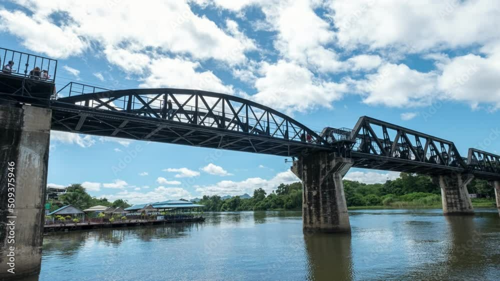 Train running on River Kwai bridge with railway station Train running on River Kwai bridge with railway station