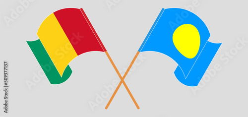 Crossed and waving flags of Guinea and Palau