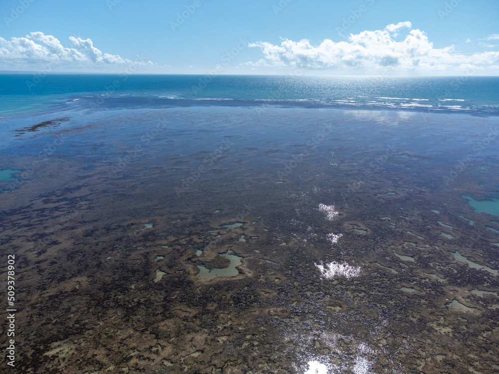 Amazing coral reef in the middle of the sea in Porto Seguro, Bahia, Brazil - natural beauty aerial drone view