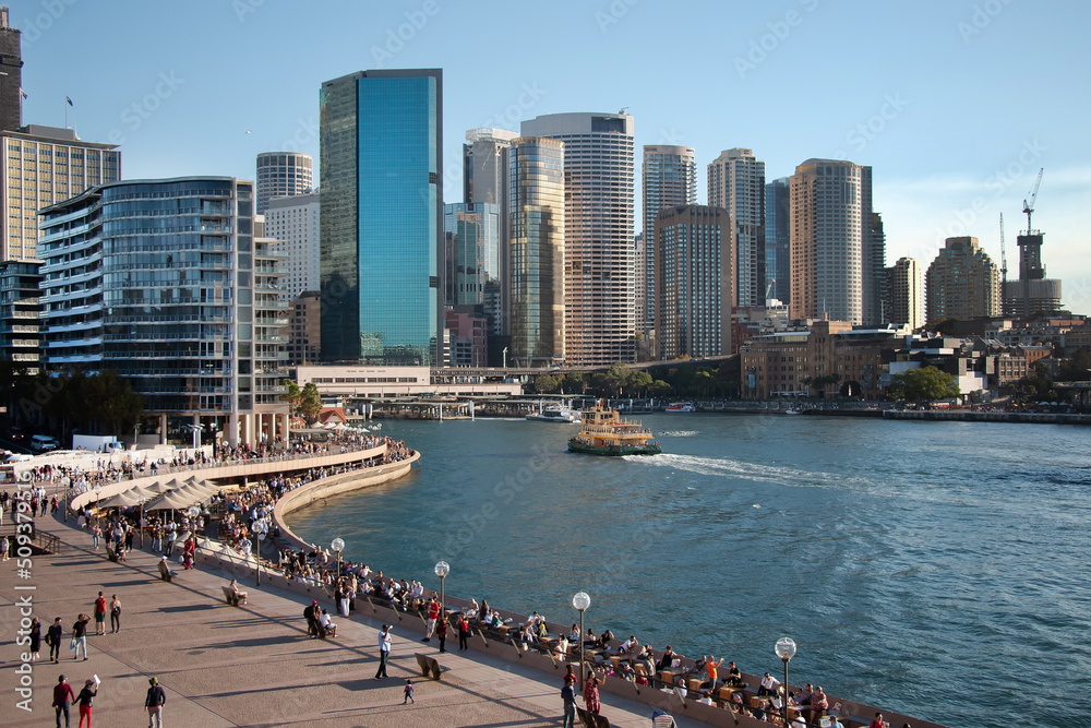 Fototapeta premium Cityscape, Sydney harbor, swarming with crowds of people and a line of skyscrapers, Australia