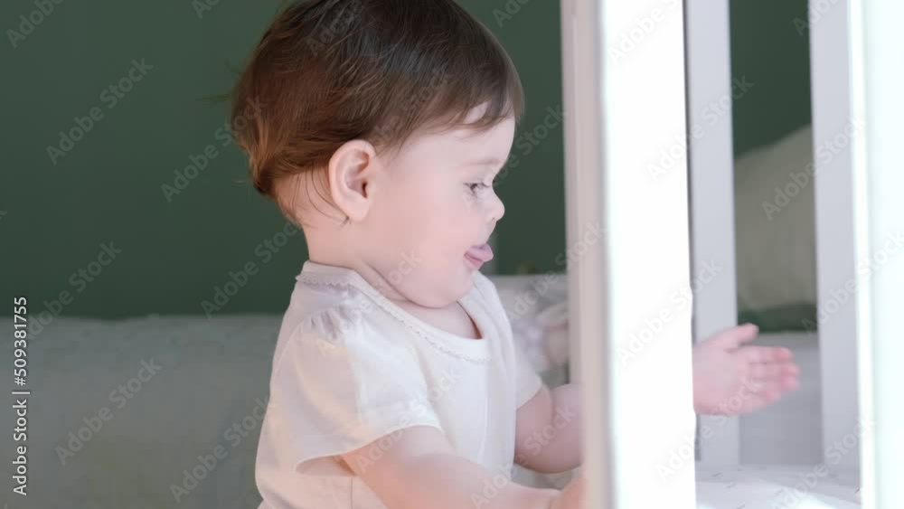 Portrait of curious child at home, Little caucasian baby girl looks into camera, Happy childhood, games at home. Portrait of curious child at home, Little caucasian baby girl looks into camera, Happy childhood, games at home.