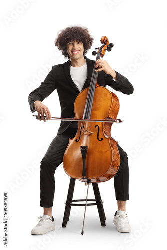 Young man sitting on a chair and playing a cello