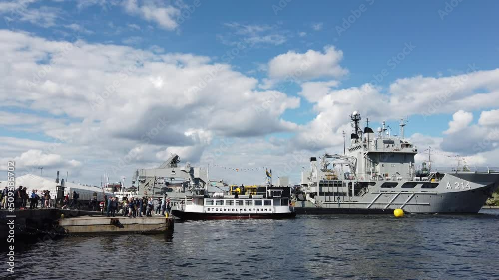 Stockholm, Sweden, June 4, 2022: Warships mingle with tourist boats in the city bay.