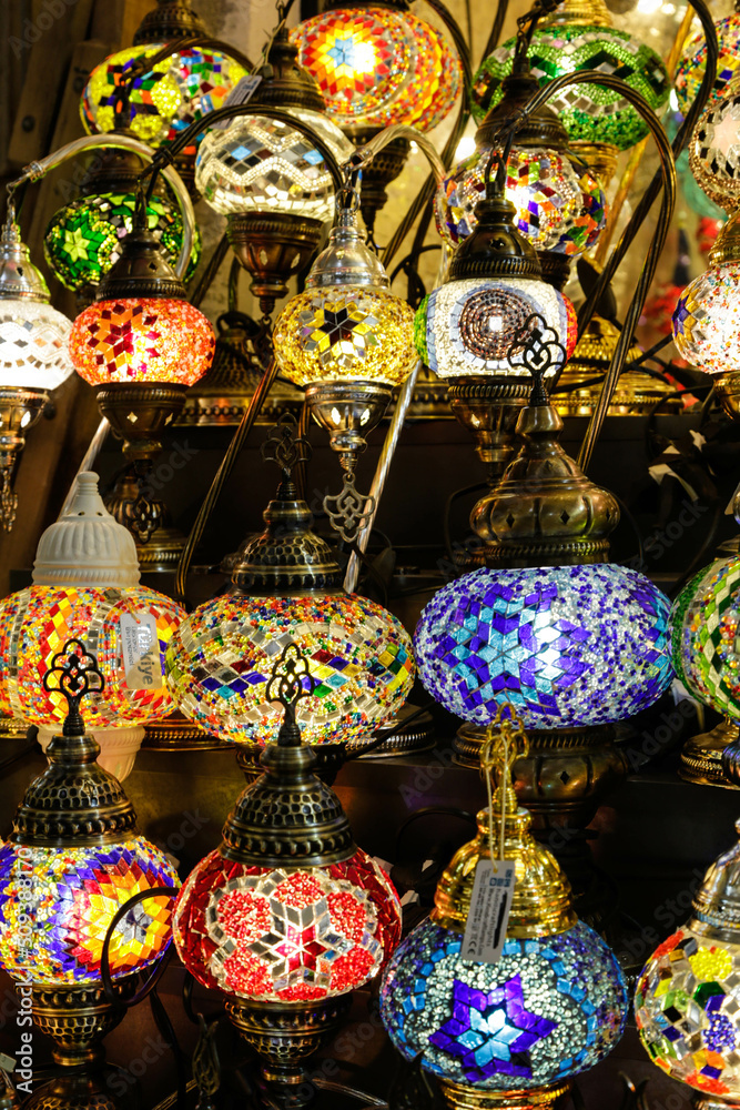 Shopping in the Grand Bazar. Traditional Turkish lamps in souvenir shop. Handmade mosaic of colored glass in Grand Bazaar.