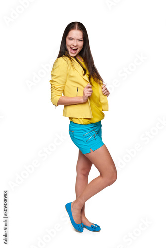 Happy screaming girl in yellow and blue clothes celebrating succes