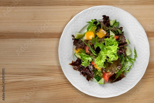 Fresh spring vegetable salad with tomatoes and peppers in the bowl.