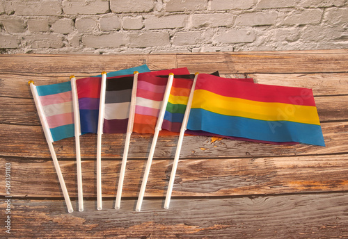 Lgtbqia2s+ gay pride fags  in a row  on wooden table  photo