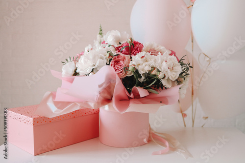 Fototapeta Naklejka Na Ścianę i Meble -  Bouquet of peonies and gift pink box, birthday concept