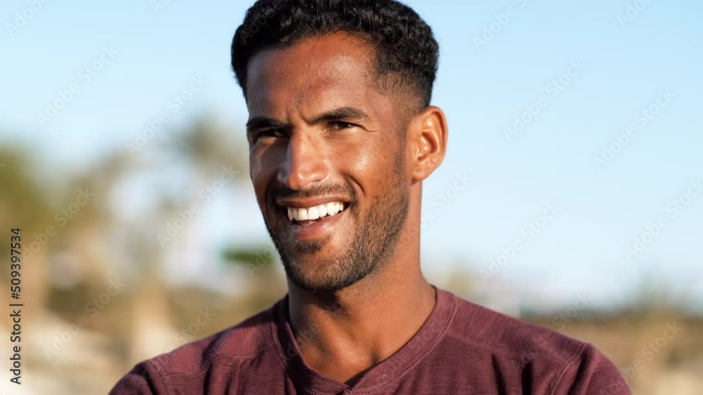 Handsome and confident, outdoor smiling portrait of relaxing young african egyptian man traveler on the beach. Handsome and confident, outdoor smiling portrait of relaxing young african egyptian man traveler on the beach.