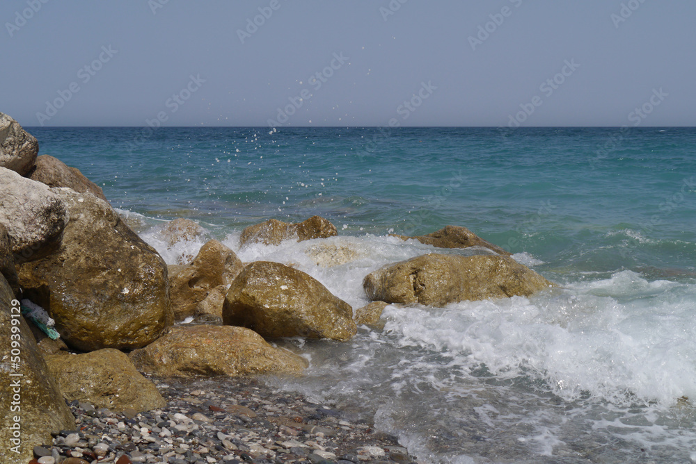 Rocks on the beach with sea waves