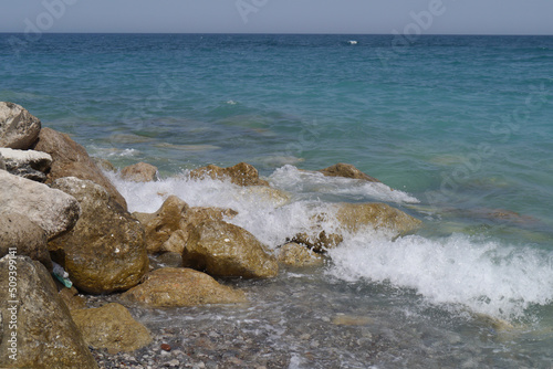 Rocks on the beach with sea waves © AnnyKen