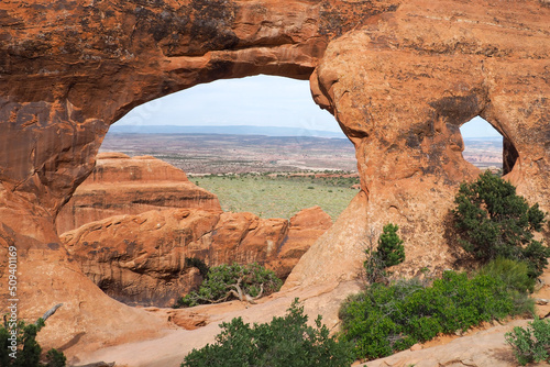 View through Partition arch in Arches National Park  Utah  USA. Natural sandstone arch formation created by erosion. Famous natural monument in the American southwest. Beautiful sunny day of spring.