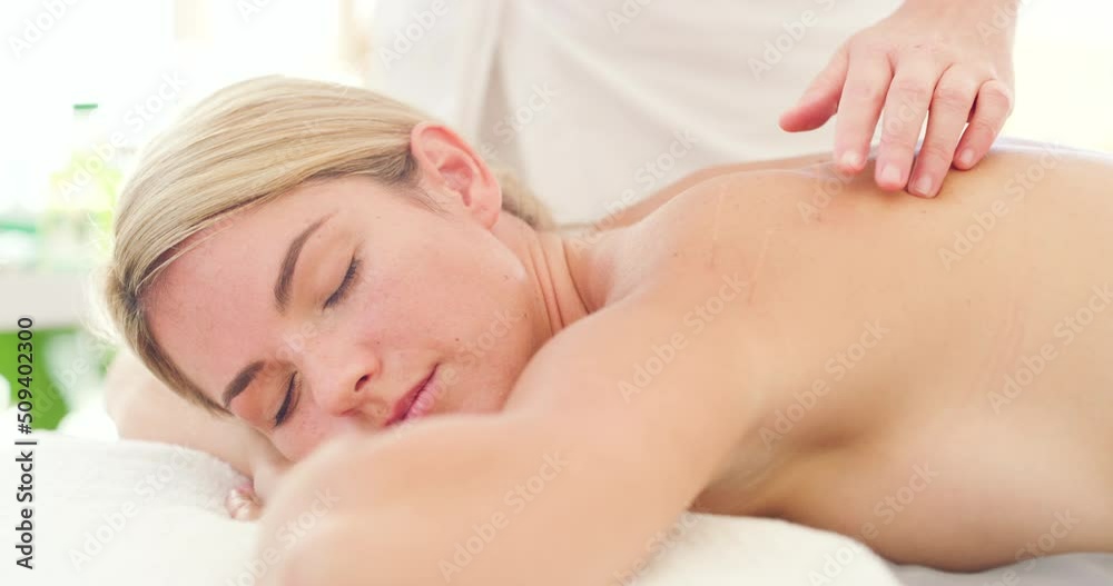 Closeup on hands of acupuncturist treating a young caucasian patient in a clinic. massage therapist inserting acupuncture needles in clients back. Alternative therapy to reduce stress and tension Closeup on hands of acupuncturist treating a young caucasian patient in a clinic. massage therapist inserting acupuncture needles in clients back. Alternative therapy to reduce stress and tension