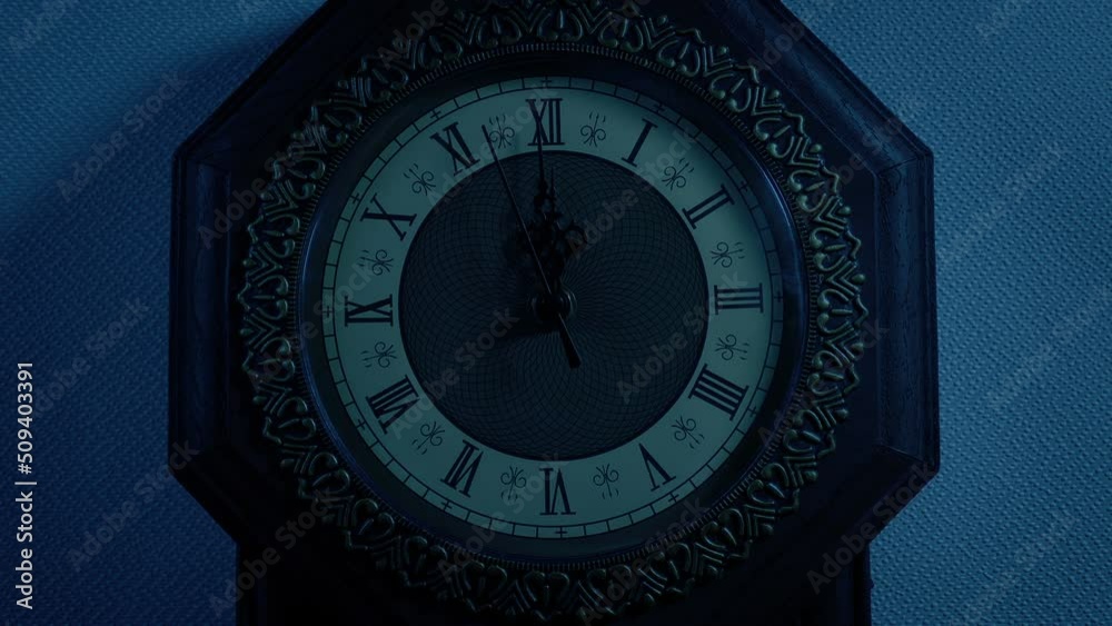 Clock Striking 12 In Dark Room Closeup