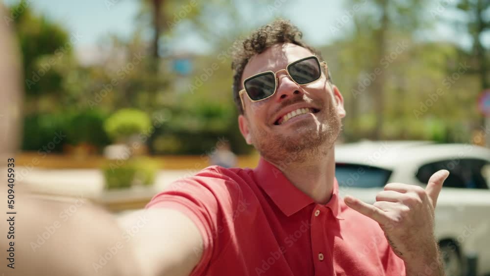 Young hispanic man smiling confident making selfie by the camera at street Young hispanic man smiling confident making selfie by the camera at street