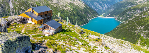 Fotografie, Obraz Alpine valley and mountain hut