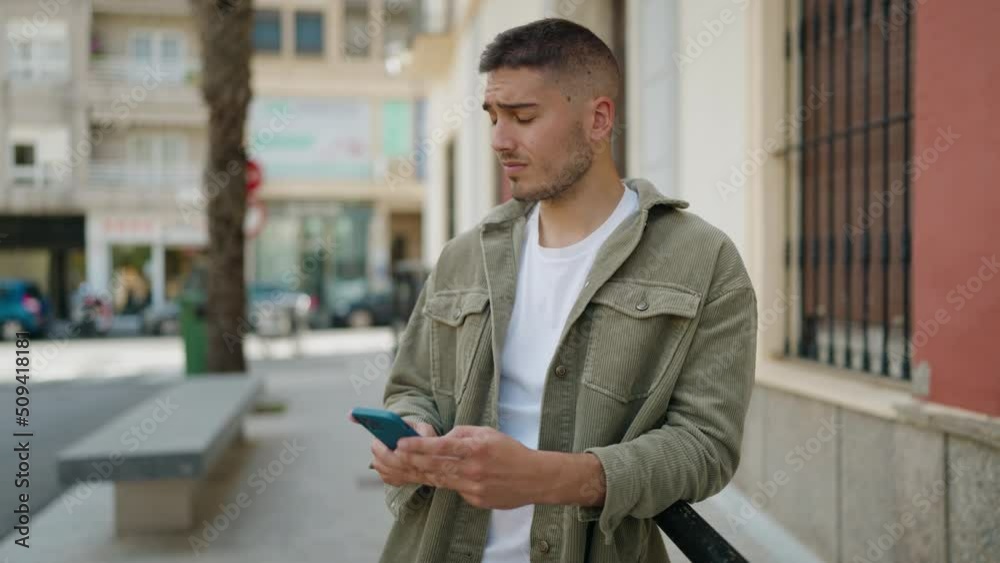 Young hispanic man smiling confident using smartphone at street Young hispanic man smiling confident using smartphone at street