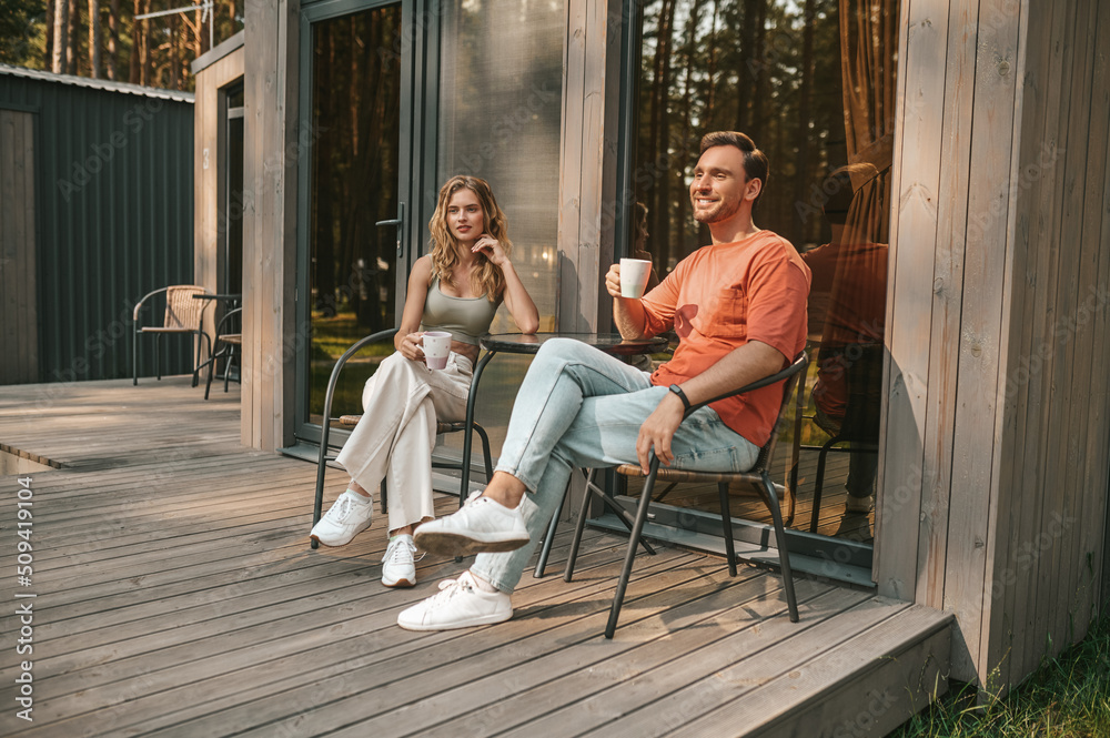 Young couple having coffee on the terrace